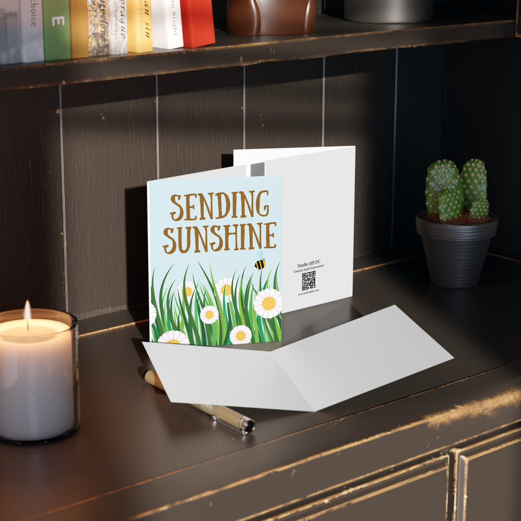 Sending Sunshine floral greeting card styled with envelope on desk