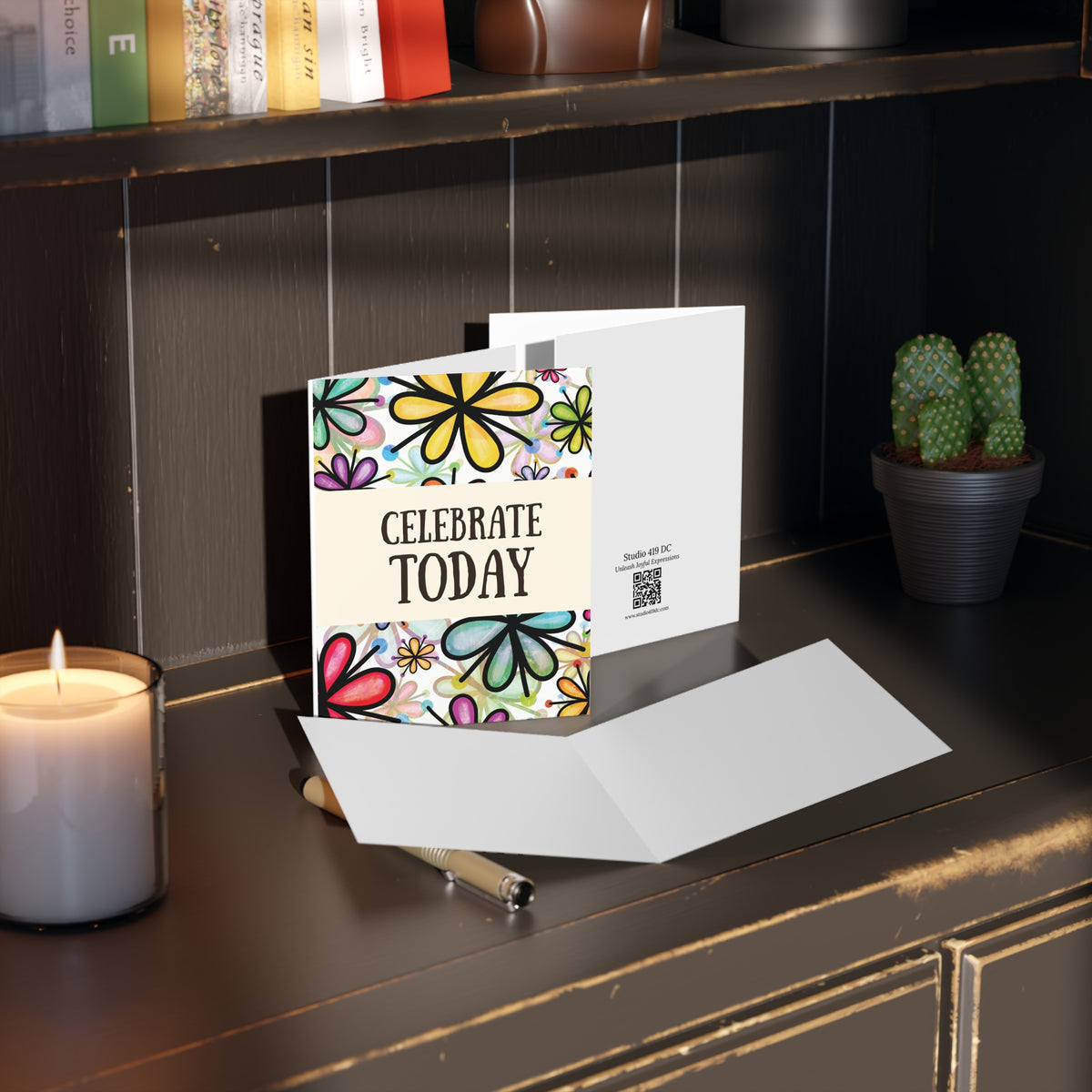 Celebrate Today floral greeting card styled with envelope on desk