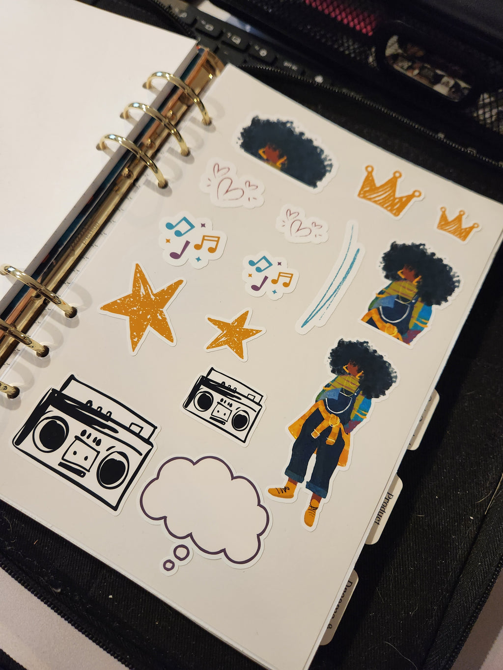 JJ sticker sheet inserted into an A5 ring-bound journal or planner for easy storage